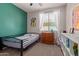 Bedroom with a bed, dresser and green accent wall at 119 W Leatherwood Ave, San Tan Valley, AZ 85140