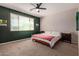 Bedroom featuring carpet, a ceiling fan, a queen-size bed, and a large window at 119 W Leatherwood Ave, San Tan Valley, AZ 85140