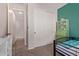 A bedroom with a charming green accent wall and closet at 119 W Leatherwood Ave, San Tan Valley, AZ 85140