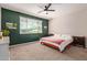 Spacious bedroom featuring a ceiling fan, carpet, and natural light from a window at 119 W Leatherwood Ave, San Tan Valley, AZ 85140