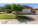 Exterior view of a well-maintained house featuring a two-car garage and green lawn at 119 W Leatherwood Ave, San Tan Valley, AZ 85140