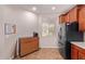 Kitchen area with wood-look cabinet, stainless refrigerator, and window at 119 W Leatherwood Ave, San Tan Valley, AZ 85140