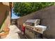 Backyard featuring stainless steel gas grill on concrete patio perfect for outdoor cooking and entertaining at 119 W Leatherwood Ave, San Tan Valley, AZ 85140