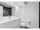 Sleek, modern bathroom with a white vanity, stainless steel faucet and black flooring at 11942 N 95Th St, Scottsdale, AZ 85260