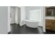 Modern bathroom with freestanding tub, black hexagon tile flooring, and natural light at 11942 N 95Th St, Scottsdale, AZ 85260