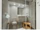 Glass-enclosed shower with a bench seat; a view of the toilet and vanity at 11942 N 95Th St, Scottsdale, AZ 85260