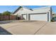 Long driveway leading to a three-car garage, surrounded by mature landscaping at 11942 N 95Th St, Scottsdale, AZ 85260