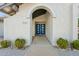 Close-up of the home's entrance featuring a striking blue double door with modern windows at 11942 N 95Th St, Scottsdale, AZ 85260