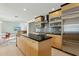 Modern kitchen with stainless appliances, island and tile backsplash at 11942 N 95Th St, Scottsdale, AZ 85260