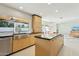 An open-concept kitchen offers a large island and seamless flow into the dining and living areas at 11942 N 95Th St, Scottsdale, AZ 85260