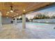 Spacious covered patio with wood ceiling, fan, and view of the pool at 11942 N 95Th St, Scottsdale, AZ 85260