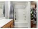 Bathroom features a shower-tub combination, white tile, and built in shelving at 12312 N 147Th Ln, Surprise, AZ 85379