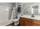 Bathroom featuring a toilet, vanity with wood cabinets, and bathtub shower combo at 12312 N 147Th Ln, Surprise, AZ 85379