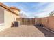 View of home's exterior showing an AC unit and a fence leading to a gravel area at 12312 N 147Th Ln, Surprise, AZ 85379