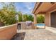 A fully equipped outdoor kitchen with an outdoor bar and barbecue at 12312 N 147Th Ln, Surprise, AZ 85379