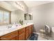 Bathroom featuring a large mirror, double sinks, and tiled flooring at 12809 W Evans Dr, El Mirage, AZ 85335