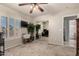 Well-lit bedroom boasting a ceiling fan, large mirror closet, and great natural light at 12809 W Evans Dr, El Mirage, AZ 85335