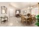 Open-concept dining room with a decorative chandelier, a mirror, and elegant furnishings at 12809 W Evans Dr, El Mirage, AZ 85335