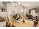 Dining room with a chandelier, and dining table set for a gathering at 12809 W Evans Dr, El Mirage, AZ 85335