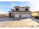 Two-story home featuring a three-car garage, neutral color palette, and low-maintenance desert landscaping at 12809 W Evans Dr, El Mirage, AZ 85335