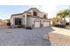 Two-story home featuring a three-car garage, neutral color palette, and low-maintenance desert landscaping at 12809 W Evans Dr, El Mirage, AZ 85335