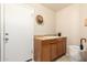 Functional laundry room with a sink, countertop, and storage cabinets at 12809 W Evans Dr, El Mirage, AZ 85335