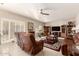 Spacious living room with neutral walls, a ceiling fan, and access to the patio via sliding glass doors at 12809 W Evans Dr, El Mirage, AZ 85335