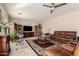 Comfortable living room with leather furniture, ceiling fan, and large entertainment center at 12809 W Evans Dr, El Mirage, AZ 85335