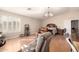 Bright main bedroom featuring a large window, hardwood floors, and a comfortable seating area at 12809 W Evans Dr, El Mirage, AZ 85335