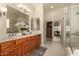 Bright bathroom features double sinks, custom cabinets, and a glass-enclosed shower at 1314 W Windsong Dr, Phoenix, AZ 85045