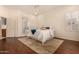 Relaxing main bedroom features wood floors, a ceiling fan, and a view of the ensuite bathroom at 1314 W Windsong Dr, Phoenix, AZ 85045