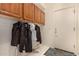 Mud Room with cabinets and hanging hooks for jackets and outerwear at 1314 W Windsong Dr, Phoenix, AZ 85045