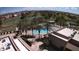 Aerial view of community pools, tennis courts, and green spaces, set against mountain views at 1403 E Las Colinas Dr, Chandler, AZ 85249