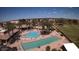 Wide aerial shot showcasing community amenities: swimming pools, lounge chairs, well kept grounds at 1403 E Las Colinas Dr, Chandler, AZ 85249