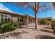 Landscaped backyard features a covered patio with a seating area and trees, providing a serene outdoor space at 1403 E Las Colinas Dr, Chandler, AZ 85249