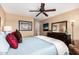 Comfortable bedroom showcases a ceiling fan, blue bedspread, pillows, and a dresser with mirror at 1403 E Las Colinas Dr, Chandler, AZ 85249