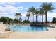 Relaxing community pool area with palm trees and a rock waterfall feature for residents to enjoy at 1403 E Las Colinas Dr, Chandler, AZ 85249