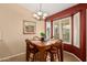 Cozy dining area with stylish chandelier, painting, and bay window with shutters at 1403 E Las Colinas Dr, Chandler, AZ 85249