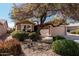 Well-maintained home with desert landscaping, a two-car garage, and a mature shade tree at 1403 E Las Colinas Dr, Chandler, AZ 85249