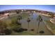 Sprawling golf course aerial with scenic water hazard and rows of palm trees at 1403 E Las Colinas Dr, Chandler, AZ 85249