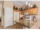 Functional kitchen with granite counters, wood cabinets, and view into the dining and living areas at 1403 E Las Colinas Dr, Chandler, AZ 85249