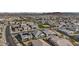 Overhead view of a sprawling residential area with solar panels, community tennis court, and desert scenery at 14317 W Faye Way, Surprise, AZ 85387