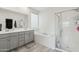 Bathroom features a double vanity with a tub and a separate glass-enclosed shower at 14317 W Faye Way, Surprise, AZ 85387