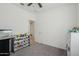 Carpeted bedroom featuring a closet, ceiling fan and toy storage shelves, perfect for organization at 14317 W Faye Way, Surprise, AZ 85387