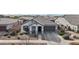 Inviting single-story home showcases a neutral color palette, manicured landscaping, and a convenient two-car garage at 14317 W Faye Way, Surprise, AZ 85387