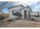 Single-story home with desert landscaping featuring a covered entrance and two-car garage at 14317 W Faye Way, Surprise, AZ 85387