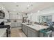 Open-concept kitchen with gray cabinetry, quartz countertops, stainless steel appliances, and a large island for seating at 14317 W Faye Way, Surprise, AZ 85387