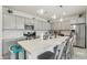 Bright, modern kitchen featuring gray cabinets, stainless steel appliances, a large quartz island, and stylish pendant lighting at 14317 W Faye Way, Surprise, AZ 85387