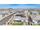 Aerial view of a home with solar panels, a patio, and artificial turf in a neighborhood with mountain views at 14325 W Faye Way, Surprise, AZ 85387