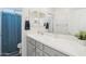 Bright bathroom with a single sink, gray vanity, and a shower with a blue curtain at 14325 W Faye Way, Surprise, AZ 85387